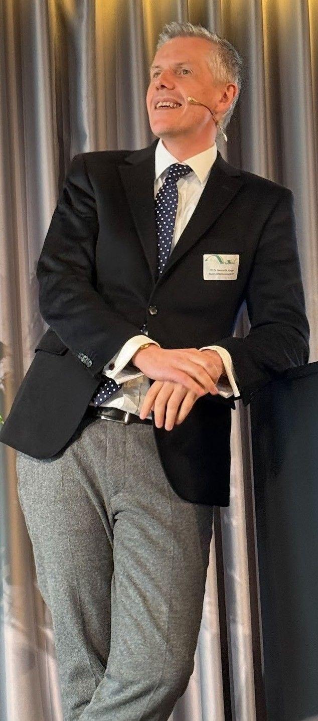 Marcus M. Keupp in a suit at a public speaking event | Solo AI website creator