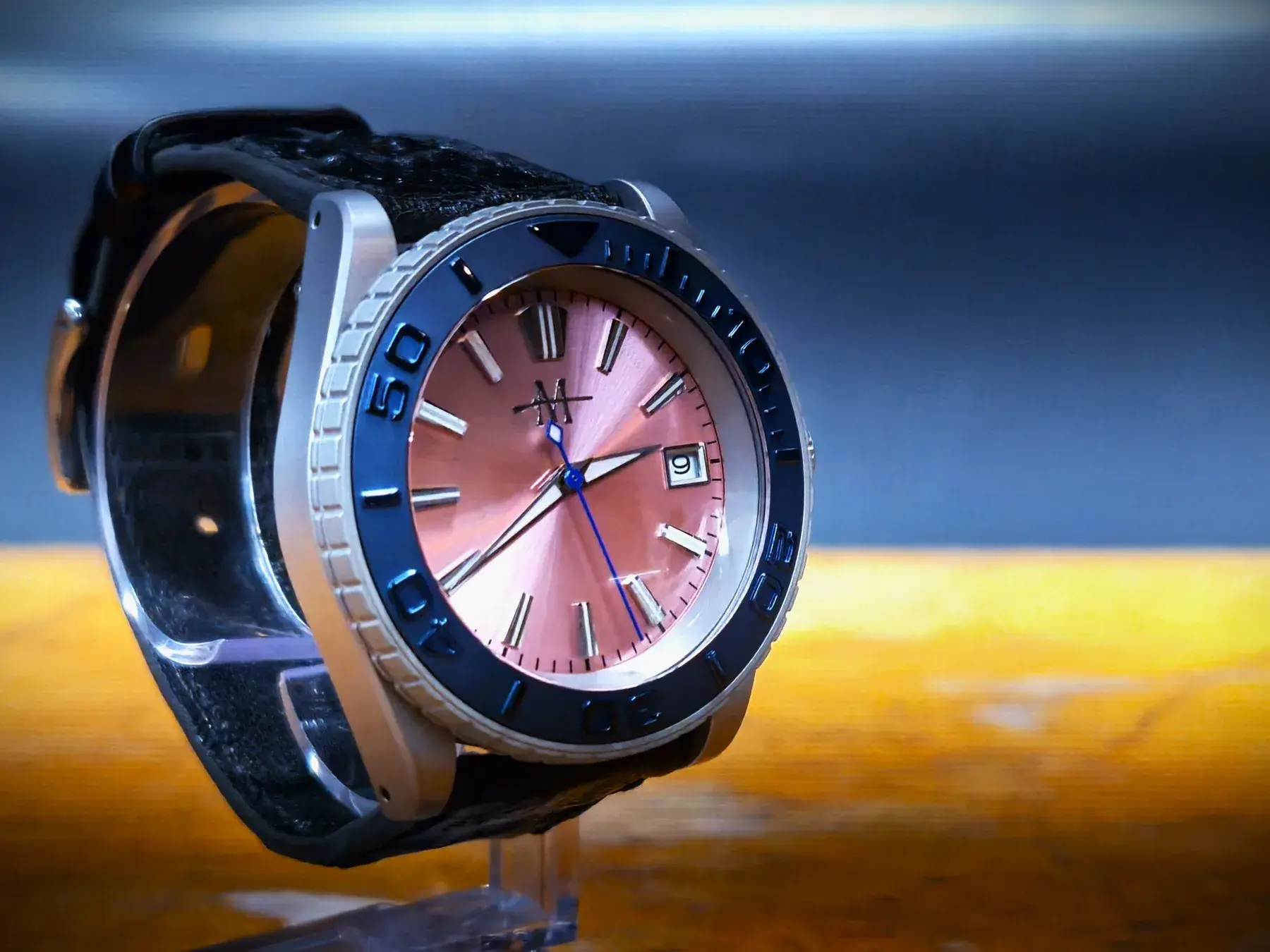 Custom wristwatch with pink dial photographed in warm light | Solo AI website creator