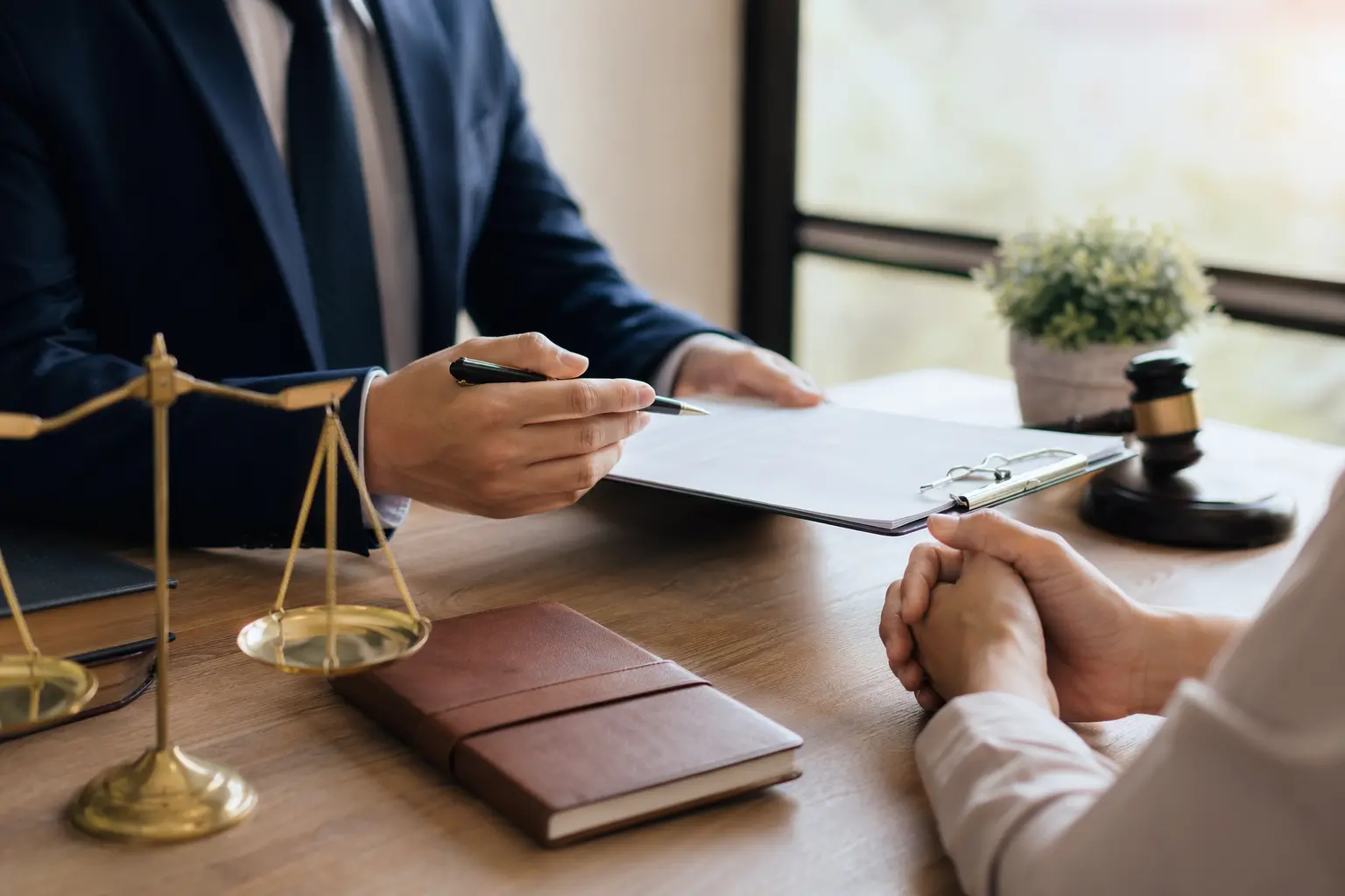 Solo for Immigration Lawyers — A man in a suit sits at a desk.