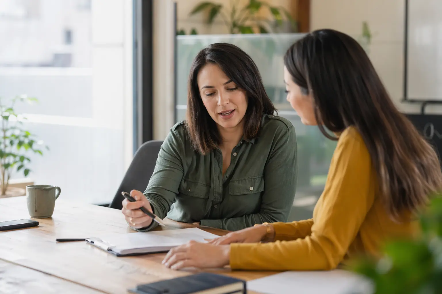 Solo for HR Consultants — A woman in a white blazer sits at a desk.