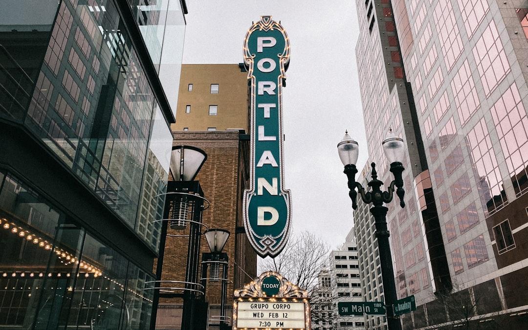 Historic Portland theater marquee with vintage neon sign in downtown urban setting
